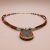 Handmade in Nepal by skilled artisans, this Inlaid Stone Pendant Necklace harmonizes White Metal, Glass, Turquoise, and Coral to invite protection, clarity, and positive energy into your life.