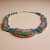 Handmade in Nepal by skilled artisans, this Inlaid Stone Pendant Necklace harmonizes the energies of White Metal, Turquoise, Lapis Lazuli, and Coral, serving as a sacred talisman for peace and balance.