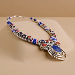 Handmade in Nepal by skilled artisans, this Tibetan stone beaded necklace harmonizes Lapis, Coral, Amber, and Turquoise, enhancing healing and spiritual growth for the wearer.