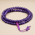 This handmade Amethyst Inspiration Stone Mala from Nepal aids meditation, fostering divine connection and inner peace while balancing the crown chakra and supporting emotional well-being.