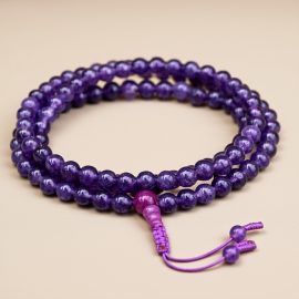 This handmade Amethyst Inspiration Stone Mala from Nepal aids meditation, fostering divine connection and inner peace while balancing the crown chakra and supporting emotional well-being.