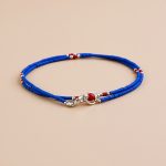 Handmade in Nepal by skilled artisans, this tiny-sized necklace of lapis lazuli, coral, and white metal beads inspires wisdom and compassion, fostering clarity and deeper self-understanding.