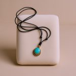 This handmade Turquoise Stone Pendant Necklace from Nepal embodies spiritual energy, promoting communication and harmony, especially for the Heart Chakra, reflecting the essence of Vajrayana teachings.
