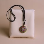 This handmade Tibetan Mantra Pendant Necklace from Nepal embodies the six perfections of Buddhism, featuring sacred materials that enhance intuition and guide one toward enlightenment.