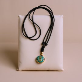 Handmade in Nepal by skilled artisans, this turquoise and lapis lazuli pendant necklace embodies Tibetan wisdom, enhancing communication and introspection on your spiritual journey.