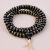 The Black Inlaid Yak Bone Prayer Mala, handmade in Nepal by skilled artisans, embodies the essence of impermanence, guiding practitioners in compassion and healing through mantra meditation.