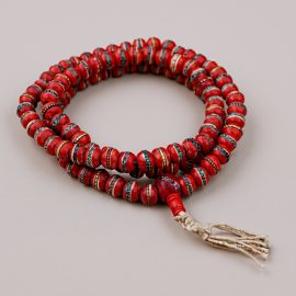 Handmade in Nepal by skilled artisans, this Yak Bone Prayer Mala features vibrant red hues, symbolizing energy and protection, and serves as a sacred tool for meditation and spiritual connection.