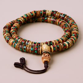 Handmade in Nepal by skilled artisans, this yak bone prayer mala features skull bead inlays, symbolizing impermanence and wisdom, guiding practitioners on their spiritual journey.