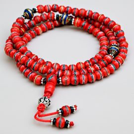 Handmade in Nepal by skilled artisans, this yak bone japa mala features inlaid mantras, serving as a spiritual tool for meditation and a reminder of life's impermanence.