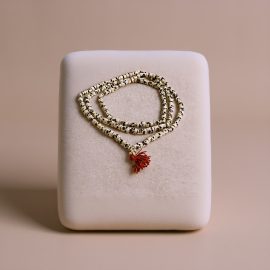 This handmade White 108 Skull Bead Yak Bone Mala, crafted by skilled artisans in Nepal, serves as a sacred tool for meditation, embodying the essence of compassion and mindfulness.