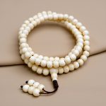 Yak Bone Prayer Mala, handmade in Nepal by skilled artisans, symbolizes the cycle of life and death, offering a sacred connection to the teachings of impermanence and transformation.