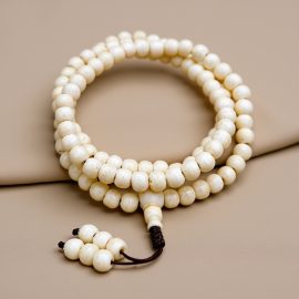 Yak Bone Prayer Mala, handmade in Nepal by skilled artisans, symbolizes the cycle of life and death, offering a sacred connection to the teachings of impermanence and transformation.