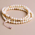 Antique Conch Shell Prayer Mala, handcrafted in Nepal by skilled artisans, serves as a sacred tool for meditation, transforming negativity into positivity and enhancing spiritual practice.