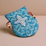 Light Blue Silk Mala Bag, handmade in Nepal by skilled artisans, symbolizes purity and spiritual devotion, enhancing your journey with calmness and compassion through its intricate Double Dorje embroidery.