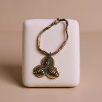 This handmade mala counter from Nepal features the face of Shakyamuni Amitabha Buddha, serving as a reminder of compassion and enlightenment in your spiritual practice.