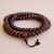 This handmade 11.5 MM Dark Brown Antique Phoenix Eye Bodhi Seed Japa Mala, crafted by skilled artisans in Nepal, aids meditation and embodies the essence of spiritual awakening and protection.