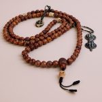 Handmade in Nepal by skilled artisans, this 12 MM Antique Phoenix Eye Bodhi Seed Mala with a counter aids meditation, embodying Buddhist teachings and enhancing your spiritual journey.