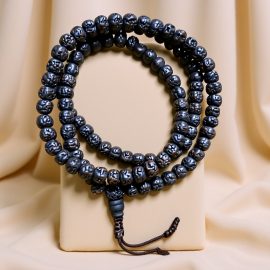 Handcrafted in Nepal by skilled artisans, this Black Rudraksha Seed Japa Mala aids meditation and spiritual connection, enhancing emotional stability and grounding one's practice.