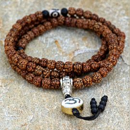 Brown Hindu Om Rudraksha Bead Japa Mala, handmade in Nepal by skilled artisans, serves as a sacred tool for spiritual practice, connecting you to divine blessings and grounding energies.