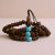 This handmade Rudraksh seed mala from Nepal, featuring turquoise spacers, embodies Lord Shiva's essence, promoting spiritual connection and protection through its sacred vibrations.