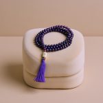 Handmade in Nepal, this Amethyst Stone Japa Mala with Yak bone Mahakala and inlaid beads supports meditation, promoting tranquility, emotional balance, and a deeper connection to the universe.