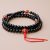 Handmade in Nepal by skilled artisans, this Black Onyx Stone Japa Mala, adorned with carnelian spacers, supports meditation and fosters grounding, emotional stability, and clarity on your spiritual journey.