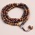 Buddha Head Tiger Eye Stone Prayer Mala, handmade in Nepal by skilled artisans, features protective tiger eye beads and symbolizes enlightenment, enhancing your meditation and spiritual journey.