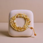 Handmade in Nepal by skilled artisans, this mala features Citrine and crystal stones, symbolizing joy and positive energy, enhancing meditation and mindfulness in your spiritual practice.