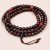 Handmade in Nepal, this Dark Red Garnet Stone Prayer Mala with Coral spacers supports meditation, enhancing vitality while promoting emotional balance and courage on your spiritual path.