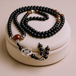 Handmade in Nepal by skilled artisans, this Double Dorje Matte Onyx Stone Japa Mala supports meditation, fostering inner calmness and balance during your spiritual practice.