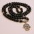 Handmade in Nepal by skilled artisans, this Hamsa Charm Lava Stone Japa Mala aids in grounding emotions, fostering courage, and inviting blessings into your meditation practice.