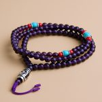 Handmade in Nepal by skilled artisans, this Imitation Amethyst Stone Yoga Mala supports meditation and mindfulness, fostering peace and spiritual growth. Embrace its calming energy on your journey.