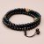 Handmade in Nepal by skilled artisans, this Japa mala features inlaid brass and black onyx, supporting your mantra practice and promoting protection and emotional growth in Vajrayana Buddhism.
