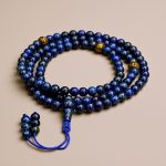 Handmade in Nepal by skilled artisans, this Lapis Lazuli prayer mala features mantra-carved beads, supporting meditation and fostering a deeper connection to the divine.