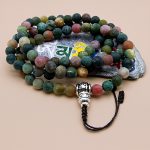 Handmade in Nepal, this Matte Blood Stone Prayer Healing Beads Mala features a mantra guru bead, supporting meditation and spiritual growth while channeling the stone's healing energies.
