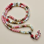 Handmade in Nepal by skilled artisans, this Multi Colour Cherry Quartz Stone Bead Mala, with Carnelian spacers, supports meditation, emotional healing, and clarity on your spiritual journey.
