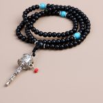This handmade Prayer Wheel Mala, crafted from Black Onyx Stone in Nepal, supports meditation and prayer, fostering inner strength and spiritual growth. A true reflection of traditional artistry.