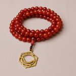 This handmade Seven Chakra Carnelian Stone Japa Mala, crafted by skilled artisans in Nepal, supports spiritual practice and meditation, enhancing balance and energy alignment within.