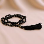 Handmade in Nepal by skilled artisans, this Tibetan Mantra Hand Knotted Matt Onyx Stone Yoga Mala supports meditation, grounding, and emotional balance on your spiritual journey.