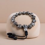 This handmade Tibetan mantra wrist mala, crafted in Nepal, features "om mani padme hum," supporting your spiritual journey towards purification and enlightenment.