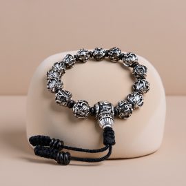 This handmade Tibetan mantra wrist mala, crafted in Nepal, features "om mani padme hum," supporting your spiritual journey towards purification and enlightenment.