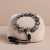 This handmade Tibetan mantra wrist mala, crafted in Nepal, features "om mani padme hum," supporting your spiritual journey towards purification and enlightenment.