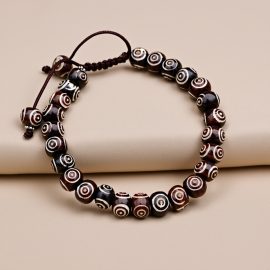 3 Eye Yak Bone Wrist Mala, handmade in Nepal by skilled artisans, serves as a spiritual tool for meditation, symbolizing life's impermanence and fostering inner strength and clarity.