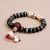 Handcrafted in Nepal by skilled artisans, this Black Bodhi Skull Inlaid Yak Bone Wrist Mala embodies the cycle of life and serves as a powerful aid for meditation and reflection.