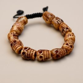 Handmade in Nepal by skilled artisans, the Calming Skull Stone Wrist Mala symbolizes impermanence, guiding us toward inner peace and clarity amidst the transient nature of existence.