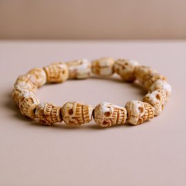 Handmade in Nepal by skilled artisans, this yak bone wrist mala features skull beads, serving as a reminder of life's impermanence and supporting your journey of spiritual growth.