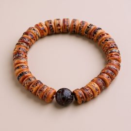 Fossil Yak Bone Wrist Mala, handmade in Nepal by skilled artisans, symbolizes life&rsquo;s impermanence and enlightenment, serving as a cherished companion for meditation and reflection.