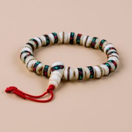Handmade in Nepal by skilled artisans, this White Inlaid Yak Bone Wrist Mala symbolizes purity and transformation, serving as a supportive companion on your spiritual journey.