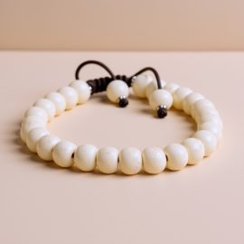 This handmade White Yak Bone Wrist Mala from Nepal serves as a sacred tool for meditation, embodying the teachings of Vajrayana Buddhism and fostering mindfulness and spiritual clarity.