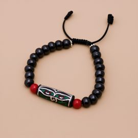 Handmade in Nepal by skilled artisans, this yak bone wrist mala features the Wisdom Buddha Eye, symbolizing spiritual awareness and the impermanence of worries, while coral stones enhance vitality.